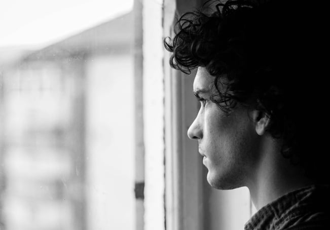 Man Standing in Front of Window